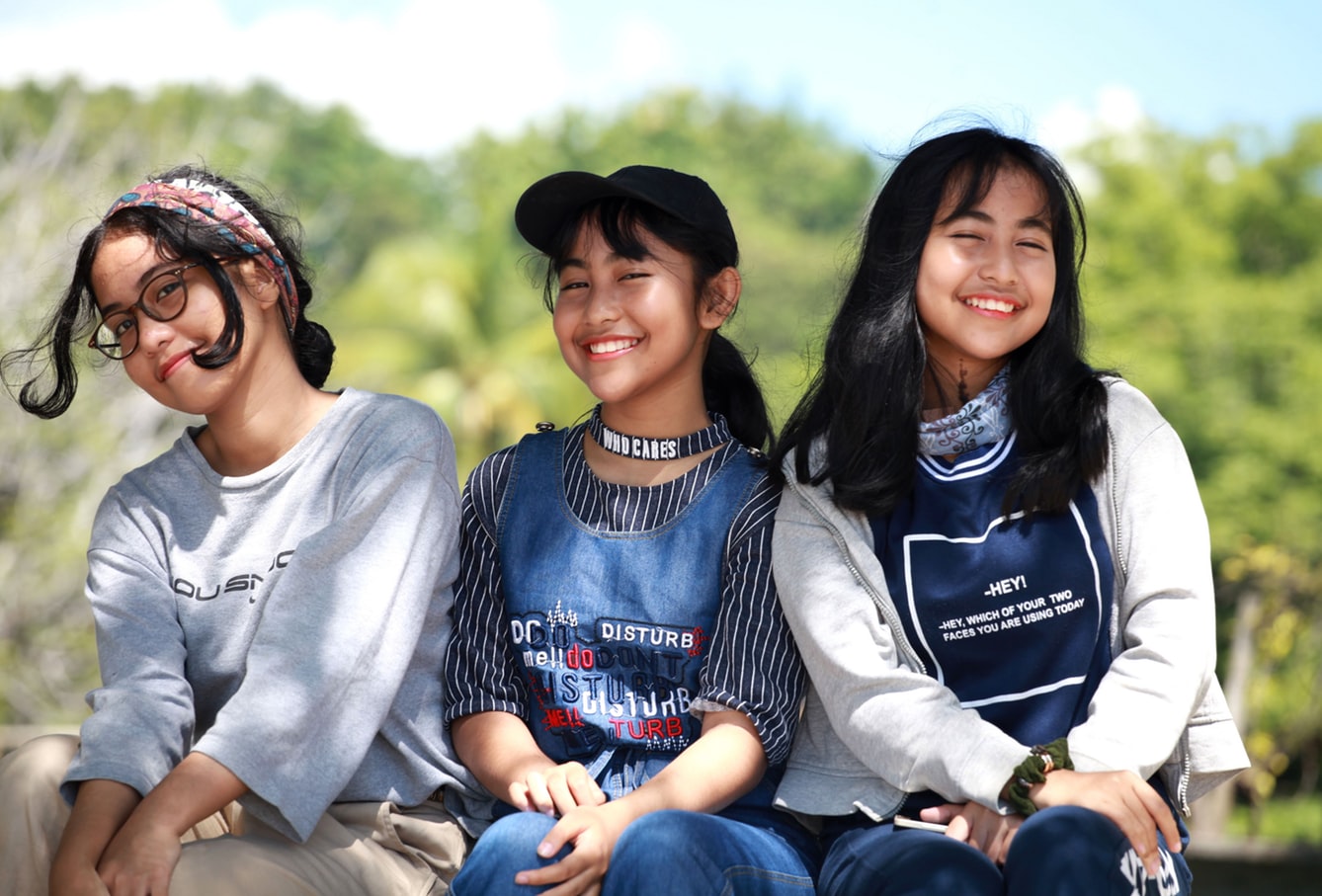 three asian teen age girls happy